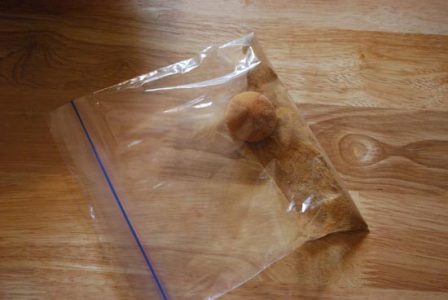 plastic bag with cinnamon and sugar mixture and a dough ball inside
